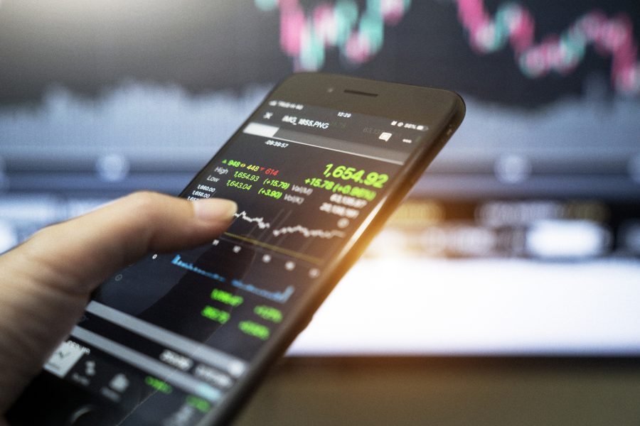 Stock market,Close up of women's hands holding smartphone