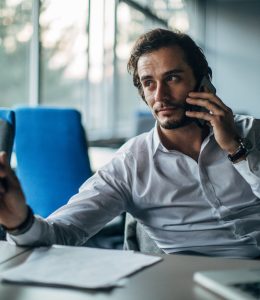 Businessman talking on mobile in office