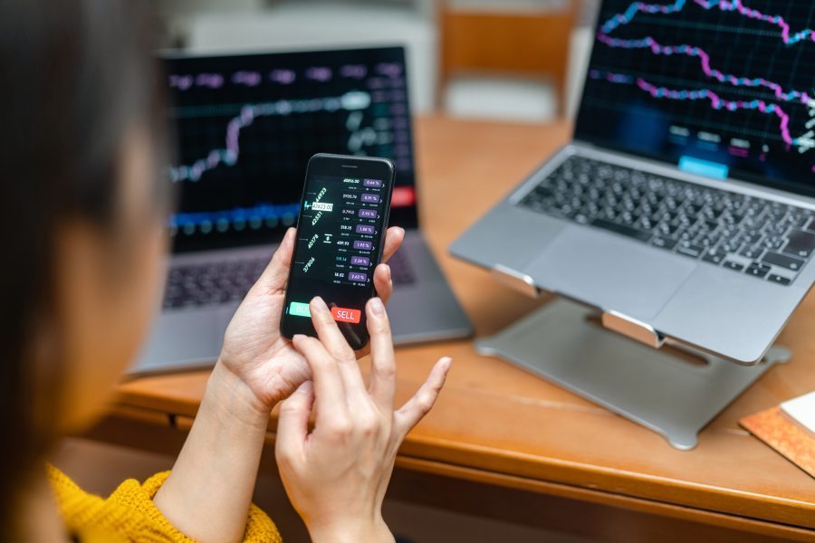 Woman checking chart for currency information on laptop. Cryptocurrency concept